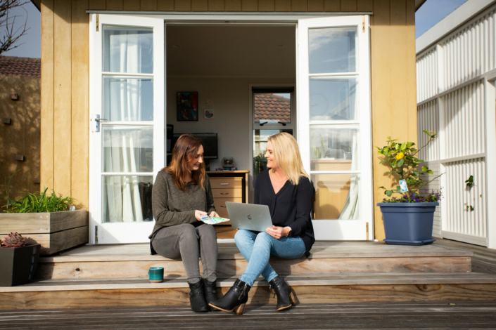 Image of Renee Orlop and designer Adele having a meeting outside the Merge Media office