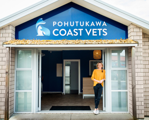 image of vet Christie standing outside the Pohutukawa Coast Vets clinic.