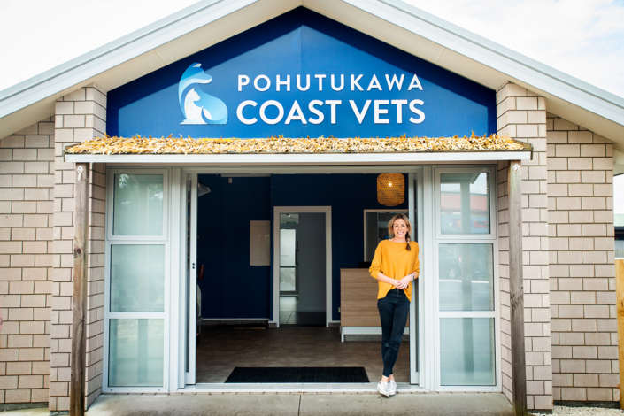 image of vet Christie standing outside the Pohutukawa Coast Vets clinic.