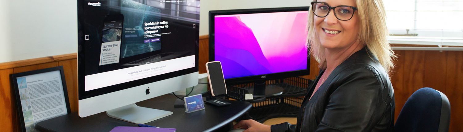 Renee Orlop Merge Media sitting at computer showing Web Hosting Services